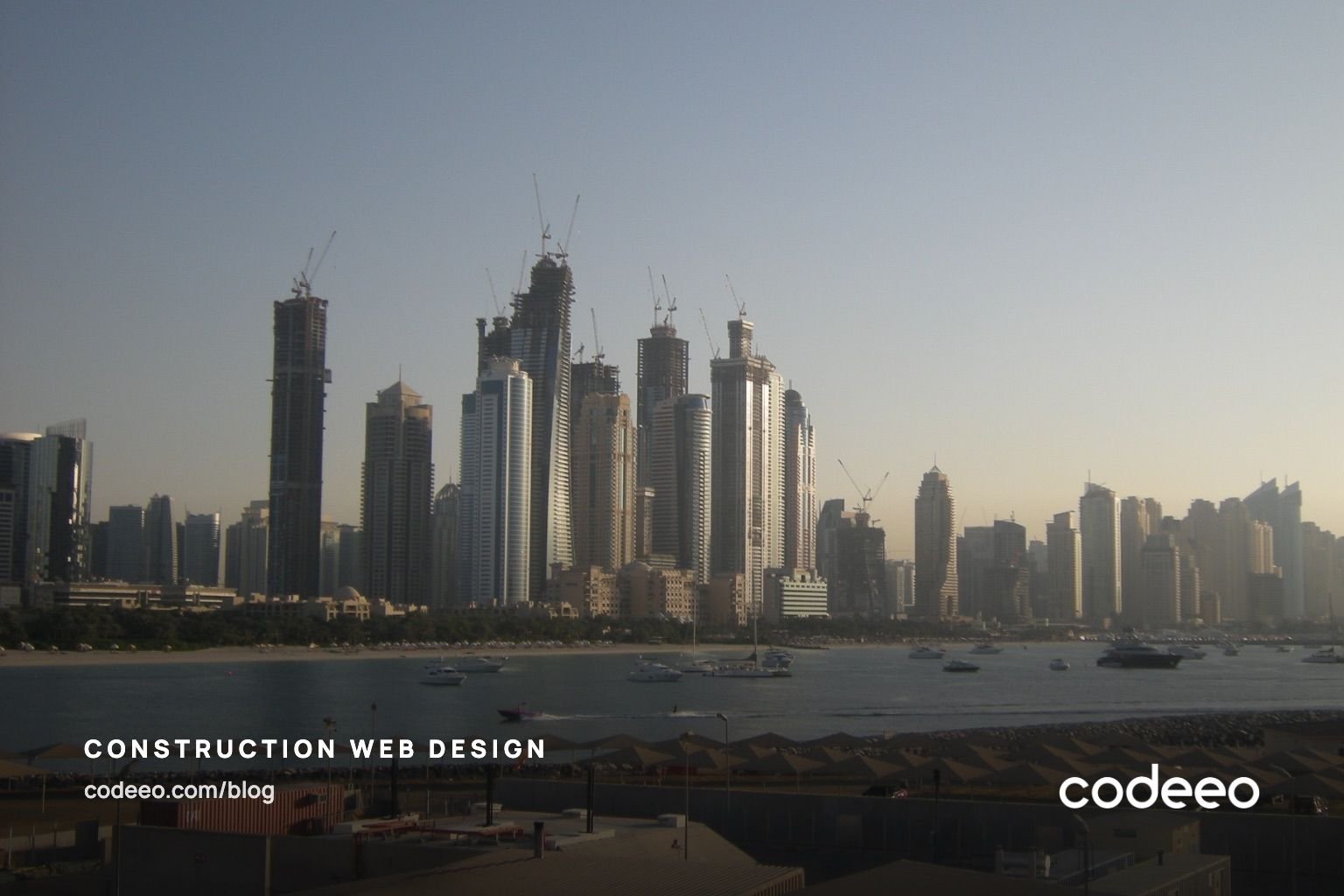 Towers under construction with cranes at Dubai Marina